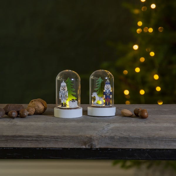 Zwei Nussknackerfiguren in Glaskuppeln mit Holzsockel, weihnachtliche Dekoration