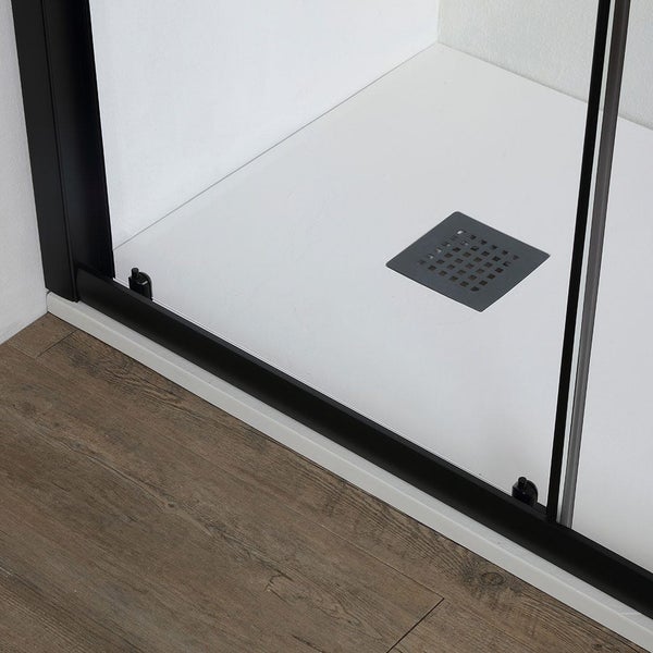 Detailaufnahme einer Duschkabine mit Ablauf und braunem Boden