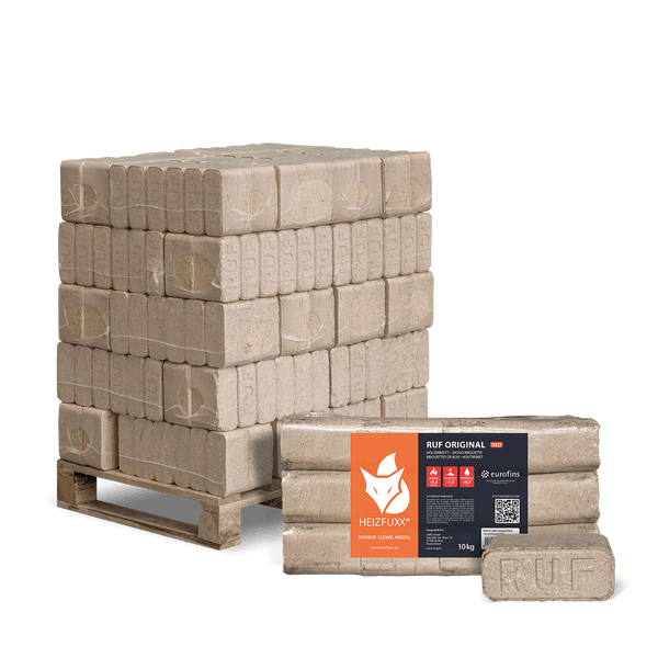 Holzbriketts gestapelt auf einer Holzpalette.