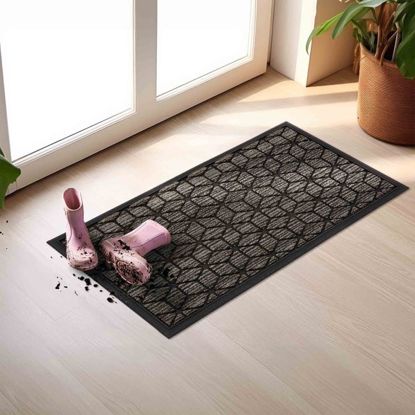 Schmutzfangmatte mit Muster und Gummistiefeln vor einer Tür