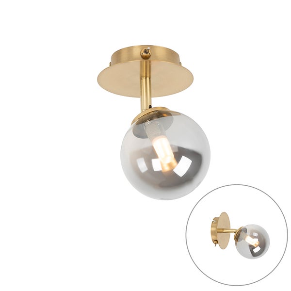 Wandleuchte oder Deckenspot aus Metall in Messing mit kugelförmigem Glasschirm und Kippschalter an der Basis.