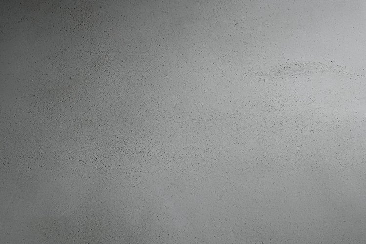 Detailaufnahme einer strukturierten Betonoberfläche mit feiner körniger Textur