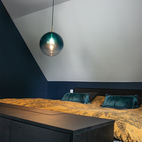 Schlafzimmer mit Deckenleuchte, Bett und Kommode