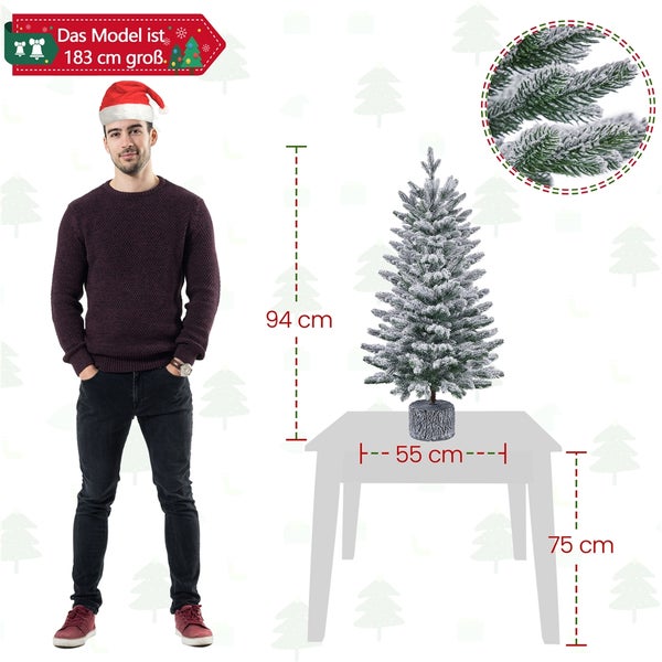 Dekorativer, schneebedeckter Weihnachtsbaum auf einem Tisch mit Größenangaben.