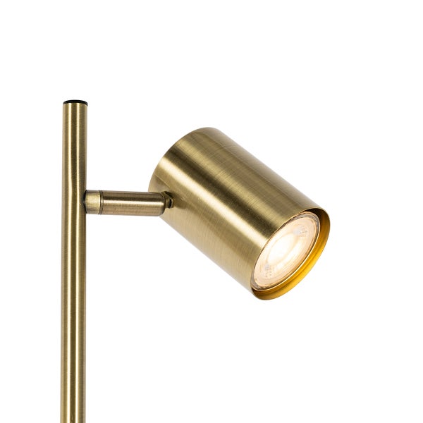 Nahaufnahme einer goldenen Stehlampe mit Scheinwerfer