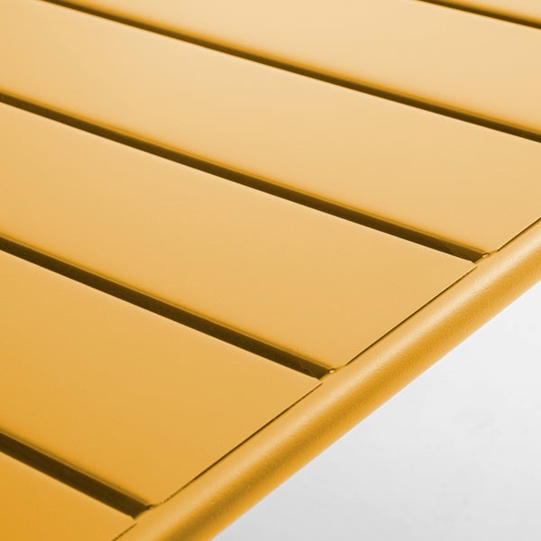Nahaufnahme einer gelben Tischoberfläche mit Metalllamellen für Gartenmöbel.
