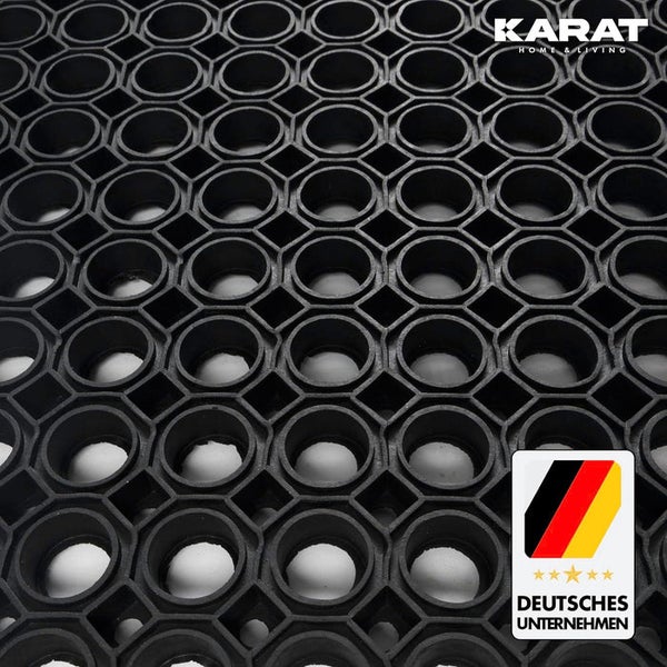 Schwarze Ringgummimatte aus Gummi mit Wabenstruktur, Karat Home & Living Logo und Hinweis auf ein deutsches Unternehmen.