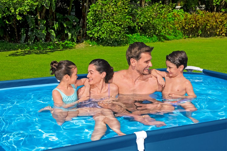Familie mit zwei Kindern in einem rechteckigen Frame-Pool im sonnigen Garten.