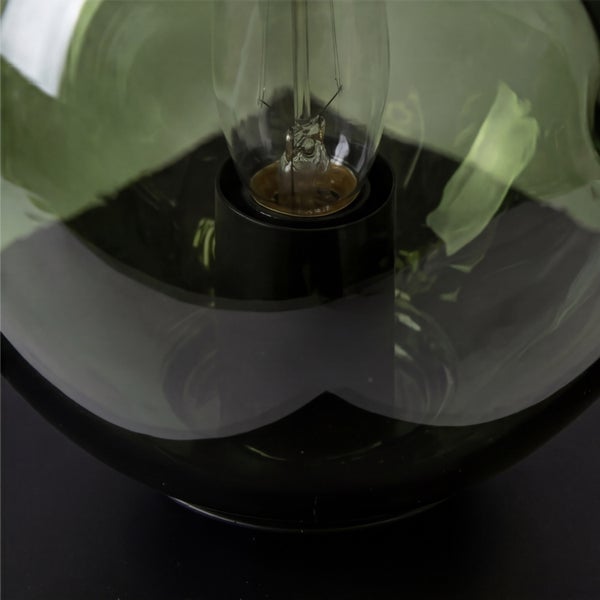 Detailansicht eines Filament-Leuchtmittels in einer schwarzen Fassung innerhalb eines gläsernen Lampenschirms.